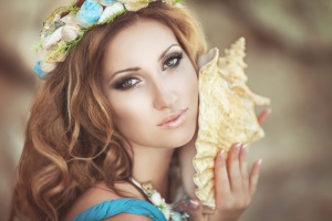 Beautiful woman mermaid with fantasy makeup in wreath